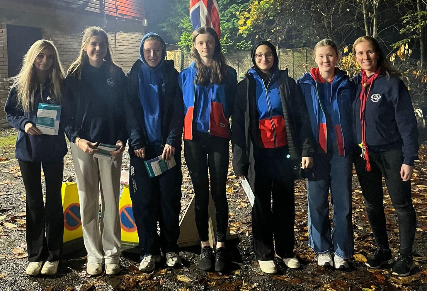 The Guides, pictured with unit leader Victoria Beattie, received their Commonwealth Awards. They are outside in the dark.