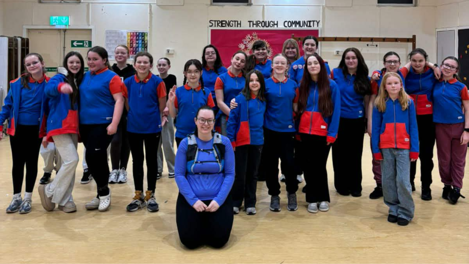 Cat Heron, kneeling in front of the 6th Clydebank Guides, all in blue uniform